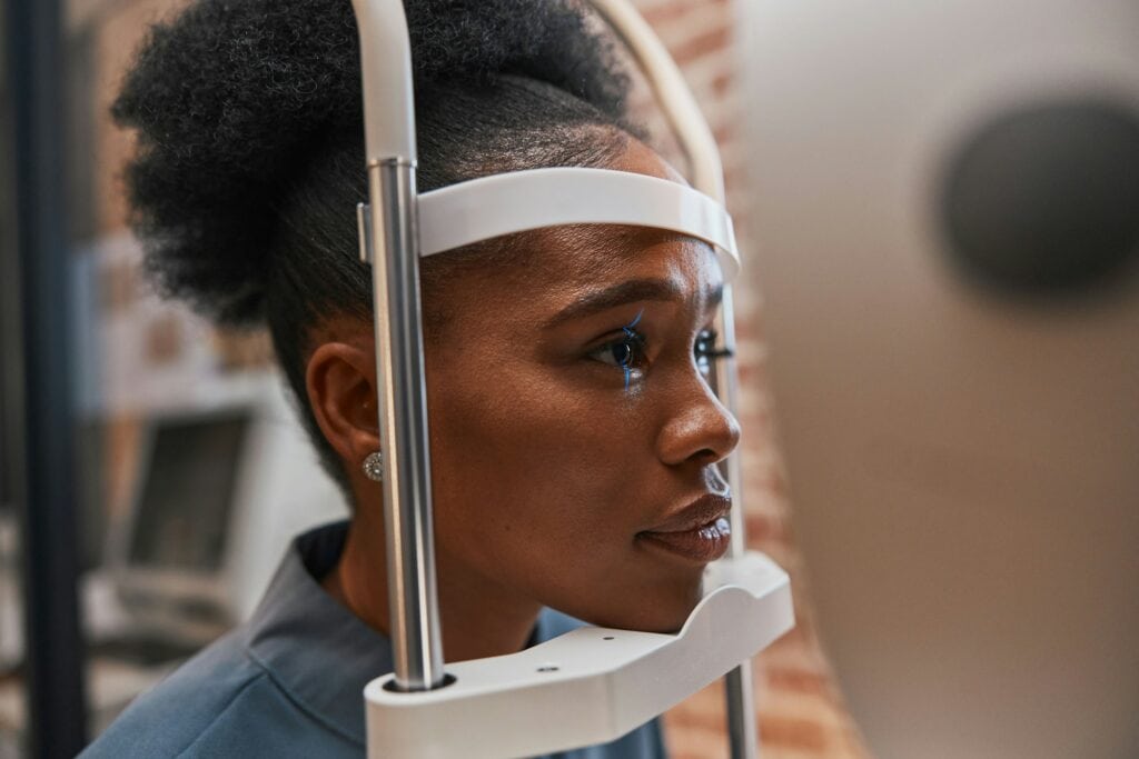 Optometry, healthcare and woman doing eye test at a clinic for optic wellness, health and vision. M